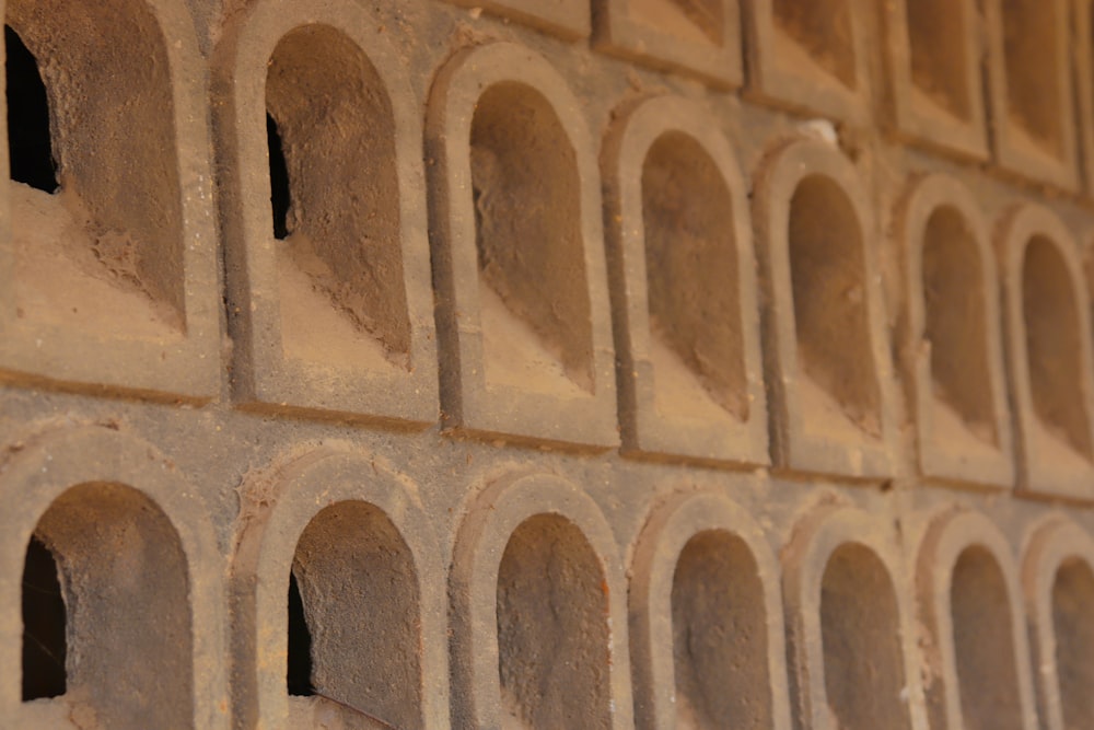 a close up of a brick wall with holes in it