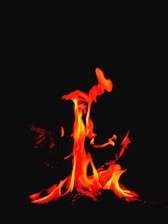 A vibrant Aries symbol glowing with fiery red and orange flames.