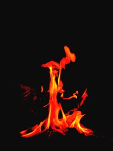 A vibrant Aries symbol glowing with fiery red and orange flames.