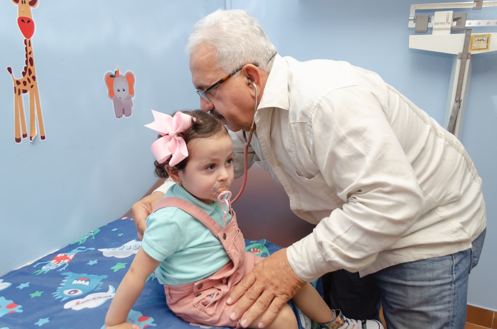 an older man and a young girl in a hospital bed