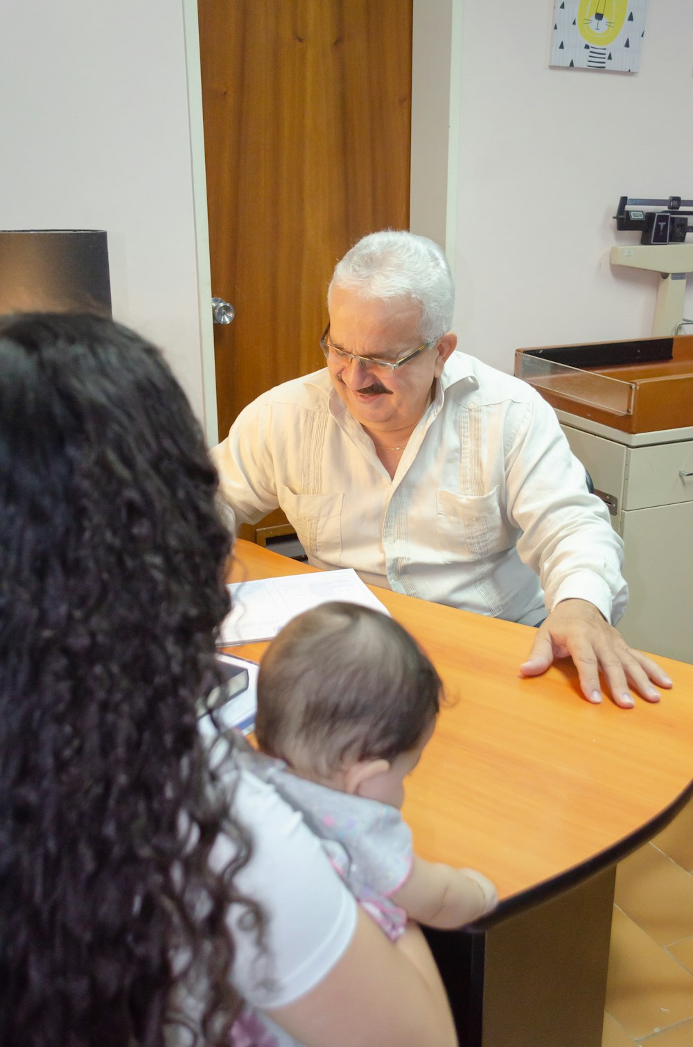 a man sitting at a table with a baby