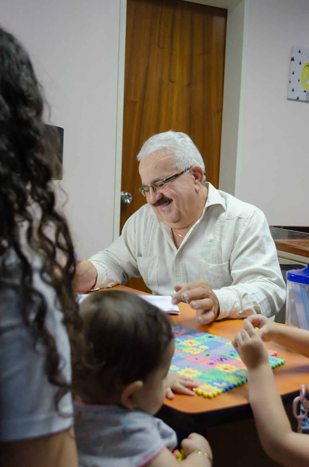 a man sitting at a table with a little girl