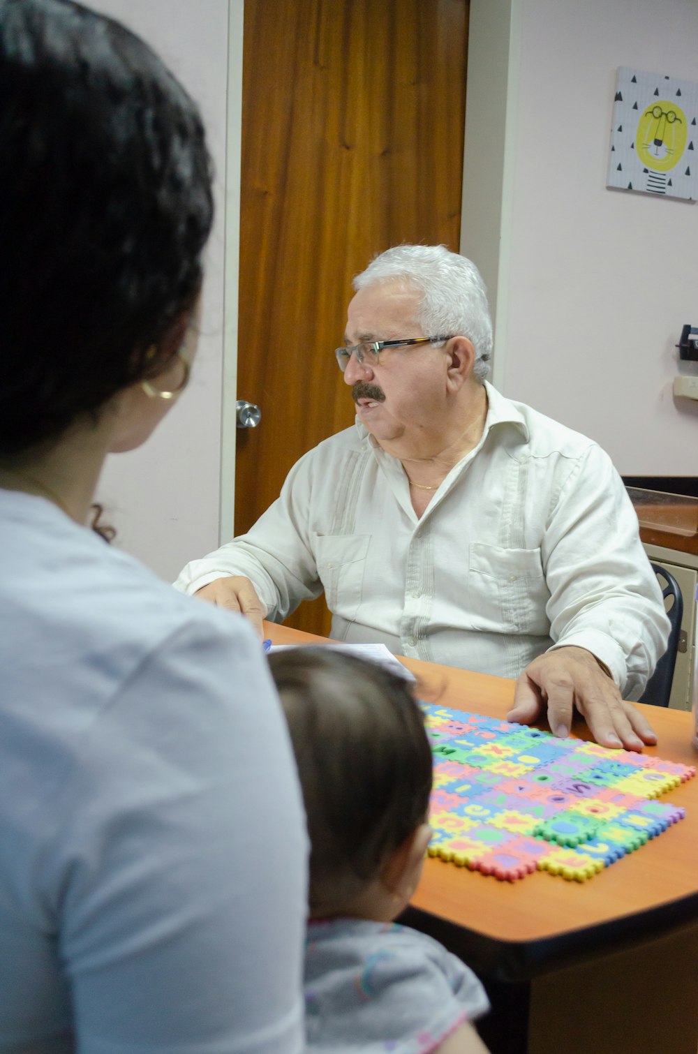 a man sitting at a table with a child