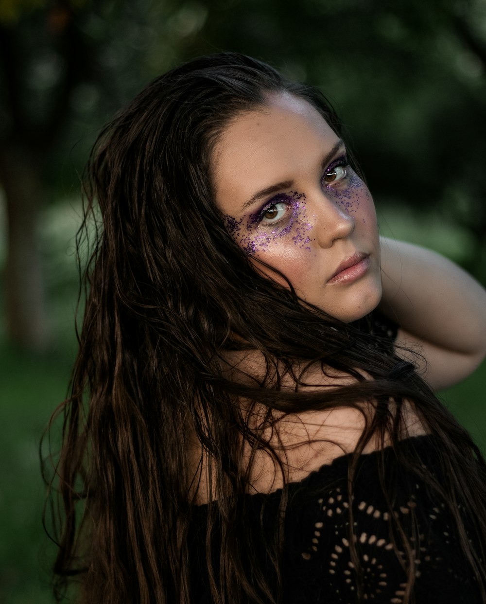 a woman with long hair and purple makeup