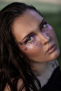 a woman with purple glitter on her face