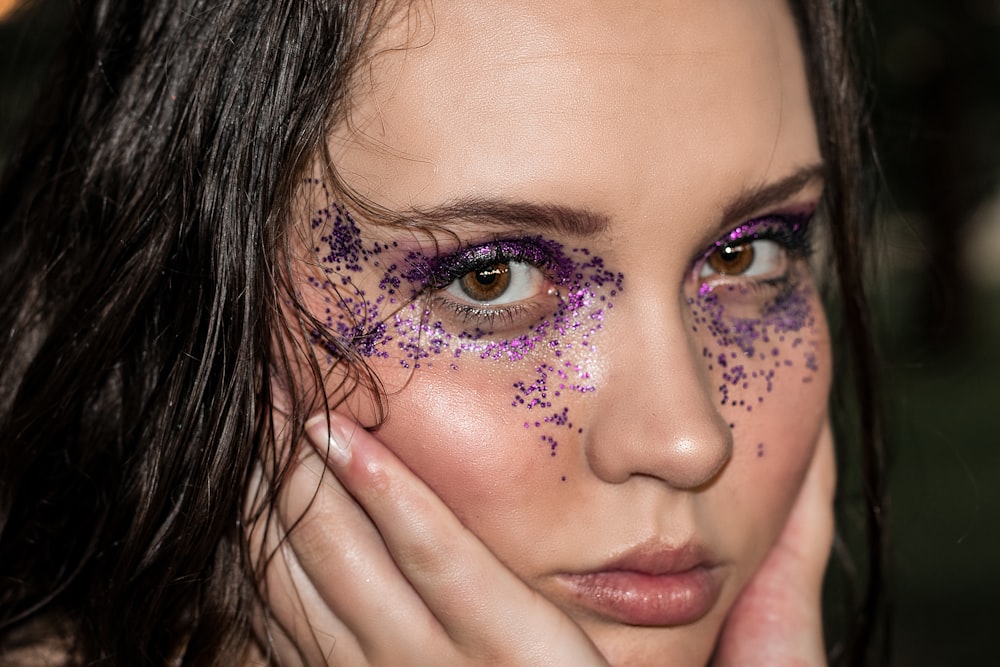 a woman with purple glitter on her face