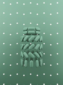 a group of pills sitting on top of a green surface