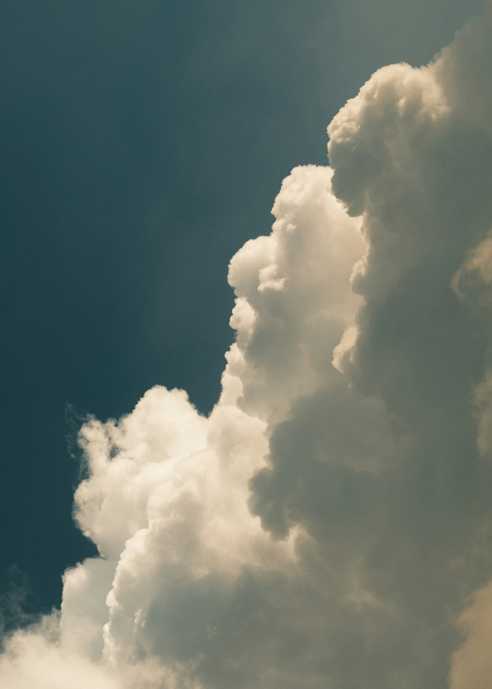 a plane flying in the sky with a lot of clouds