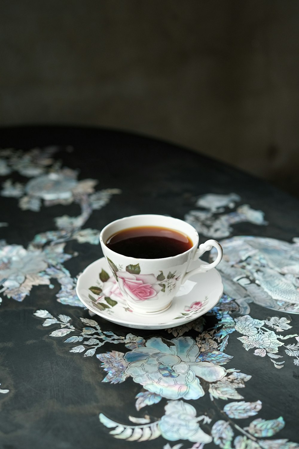 a cup of coffee sitting on top of a table