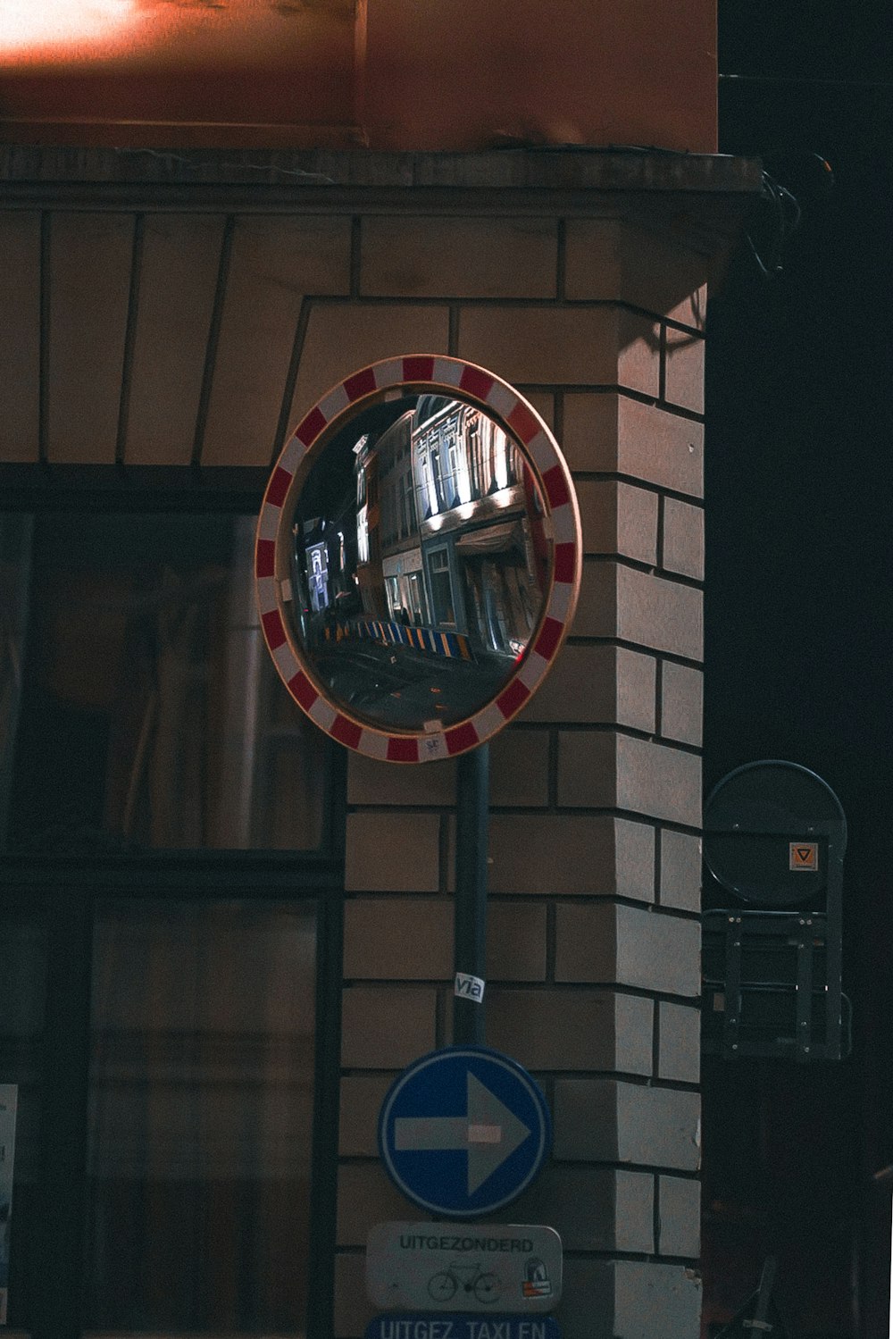 a round mirror on the side of a building