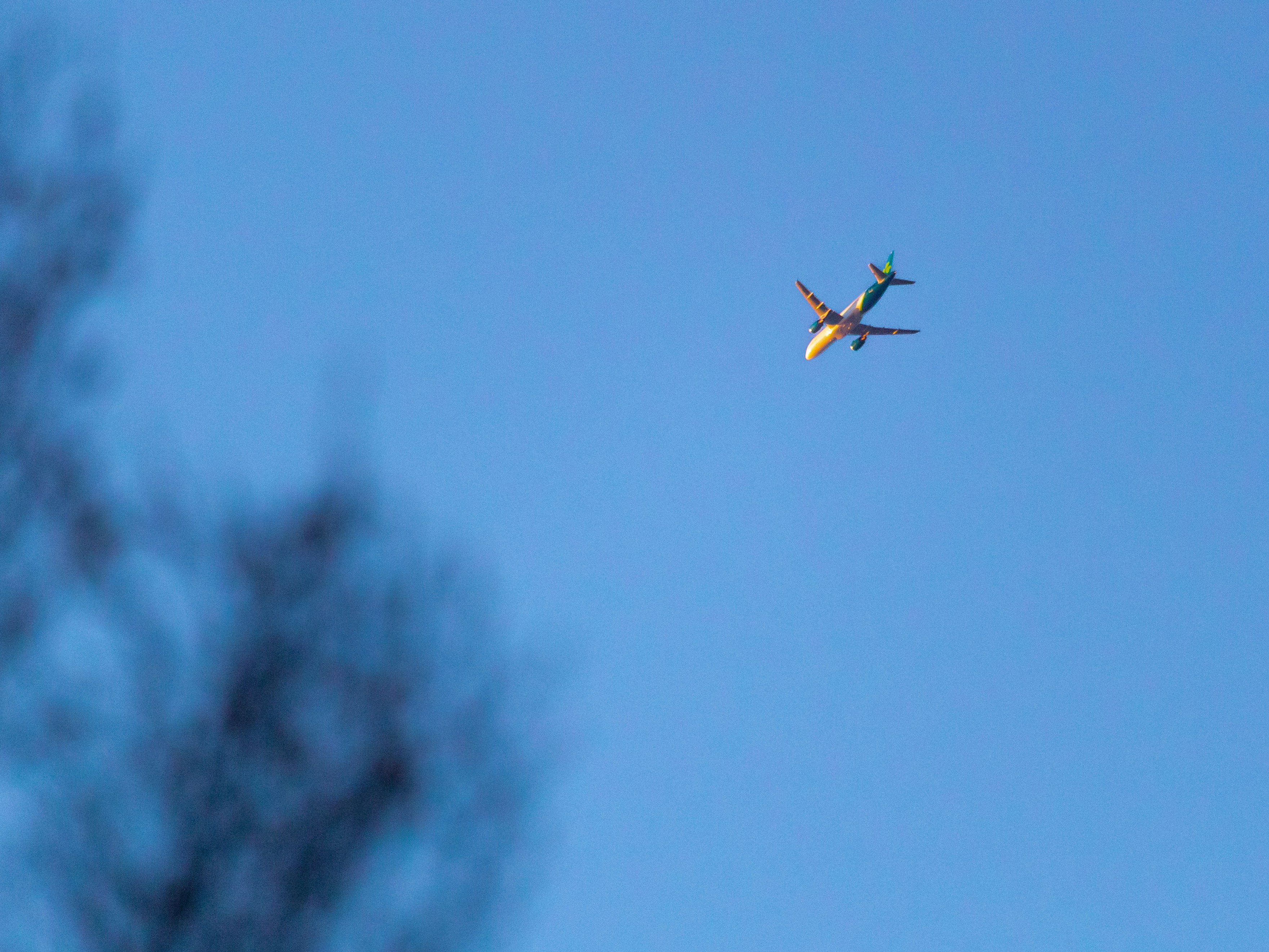 an airplane is flying in the blue sky