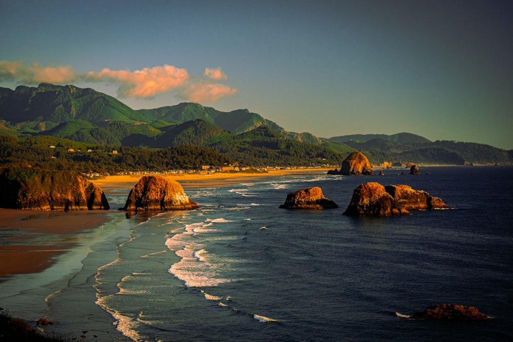 a view of a beach with mountains in the background