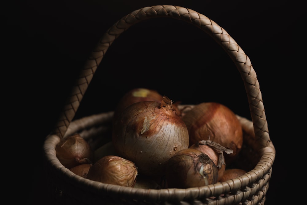a basket filled with onions sitting on top of a table