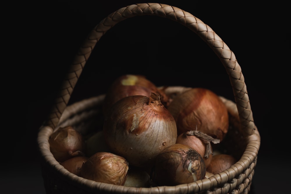 a basket filled with onions sitting on top of a table