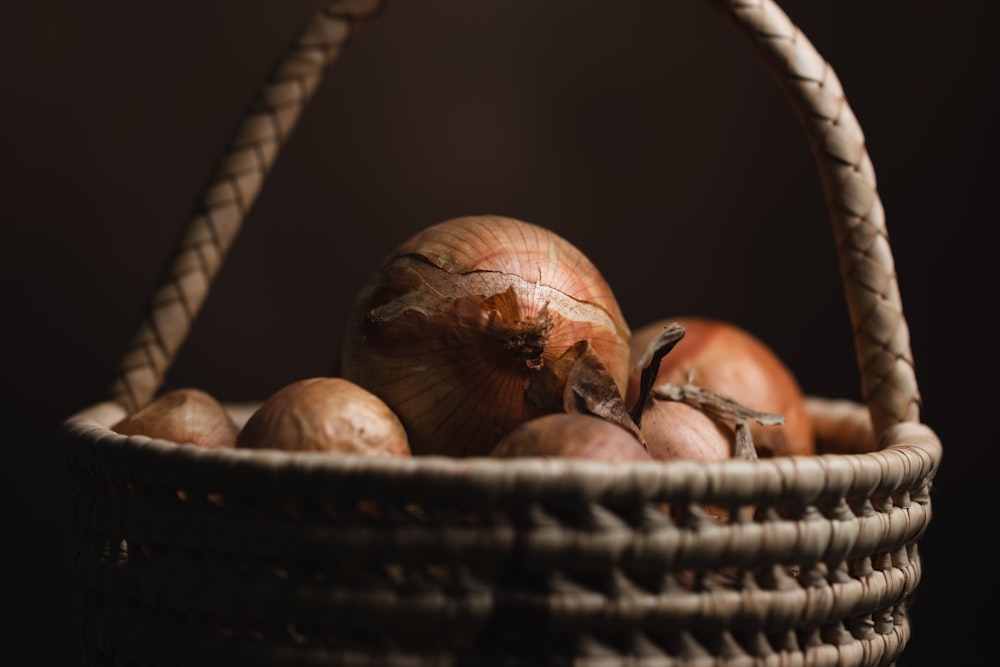 a basket filled with onions sitting on top of a table