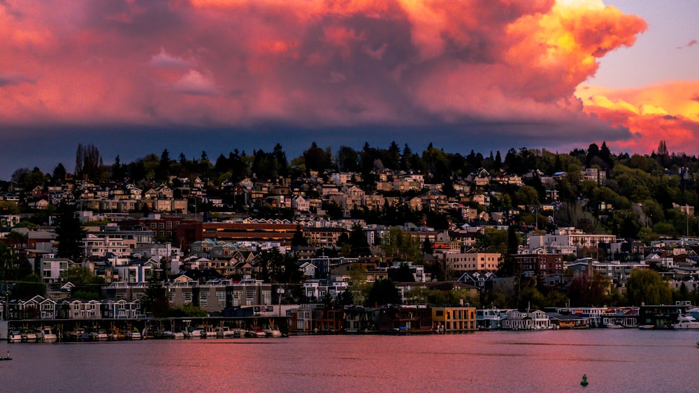 a view of a city and a body of water at sunset