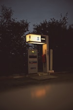 a gas station at night with the light on