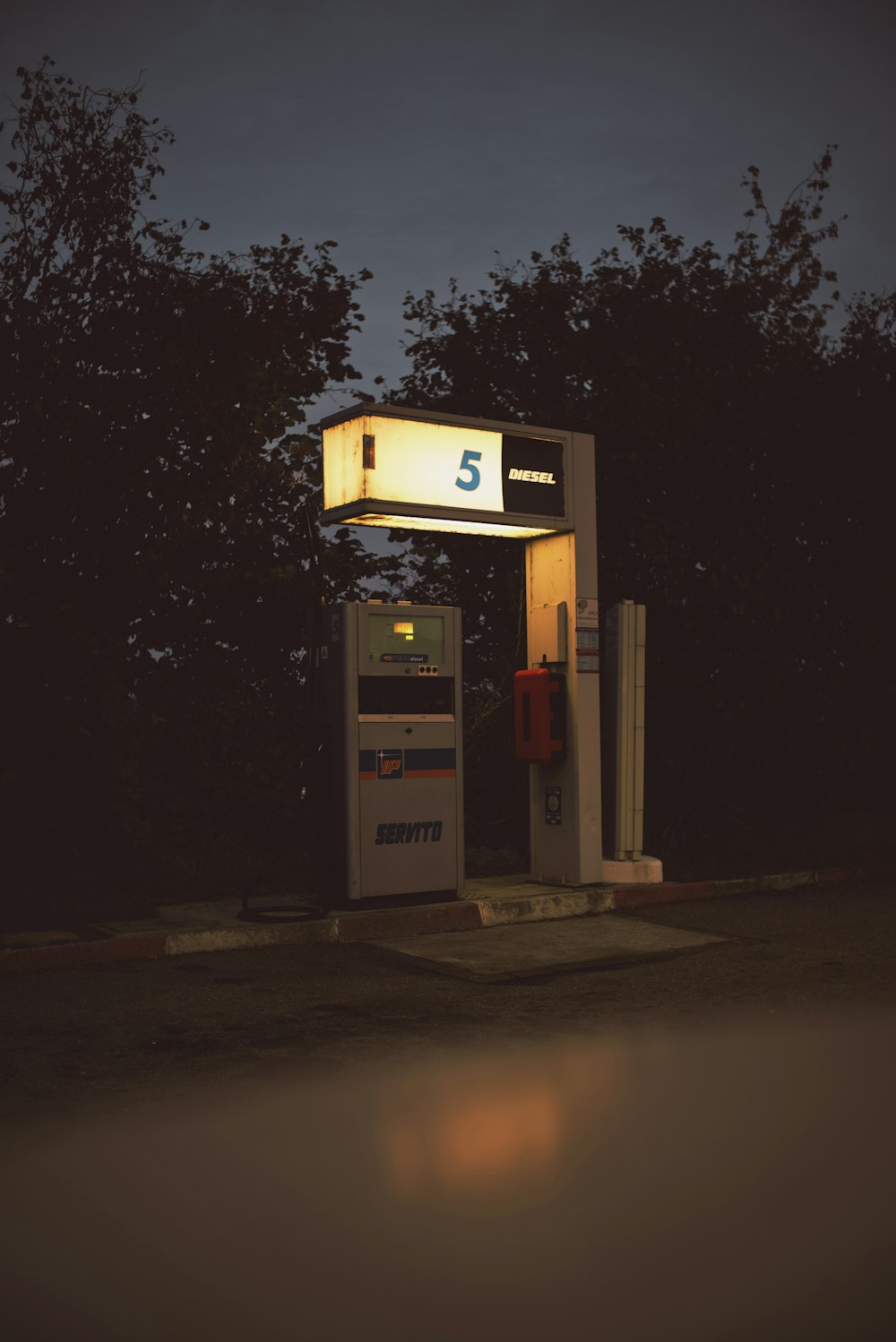 a gas station at night with the light on