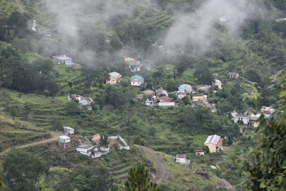 a small village nestled on a hill surrounded by trees