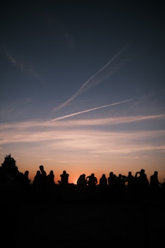 A peaceful prayer circle gathering at sunset in a community park.
