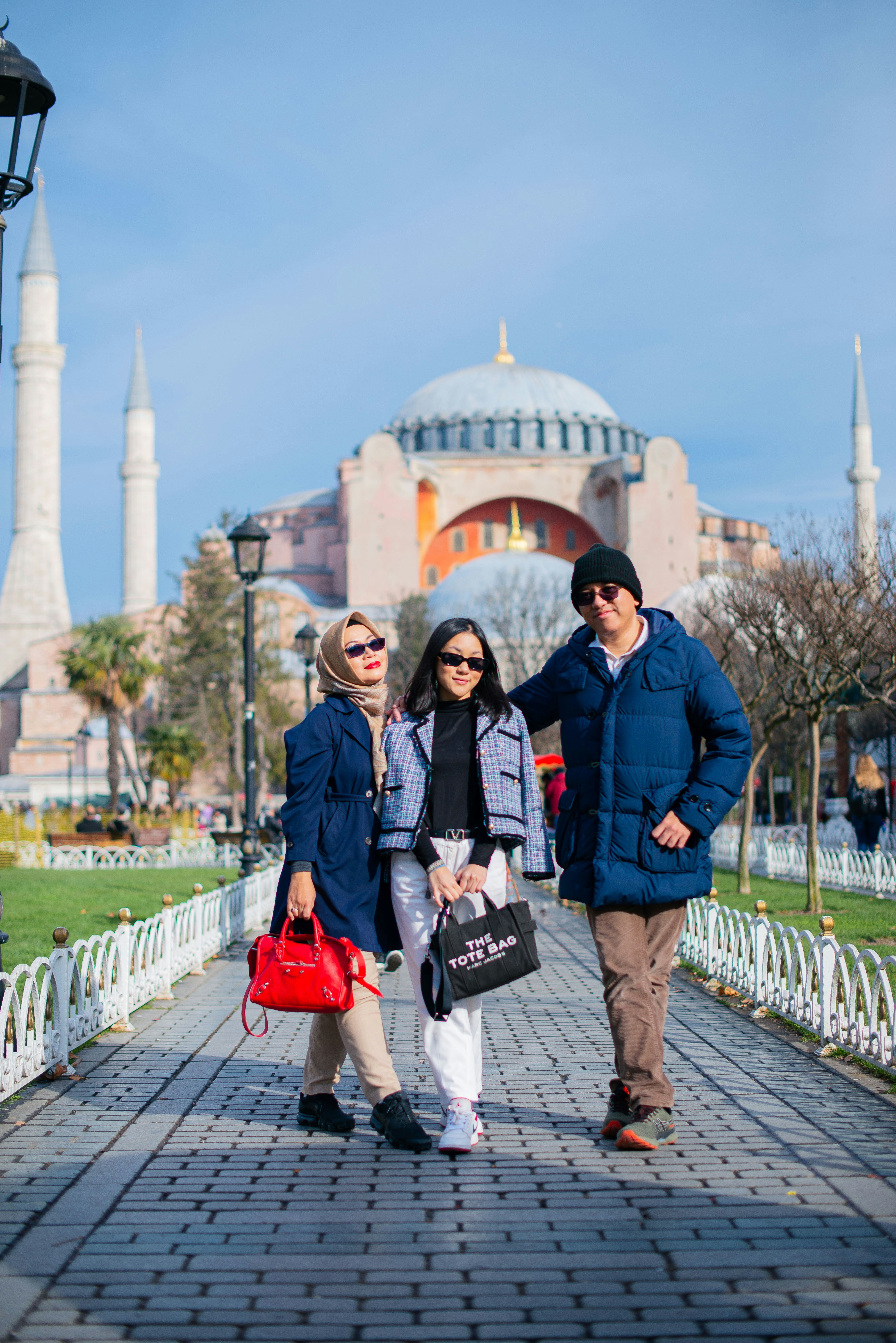 a man and two women standing in front of a building