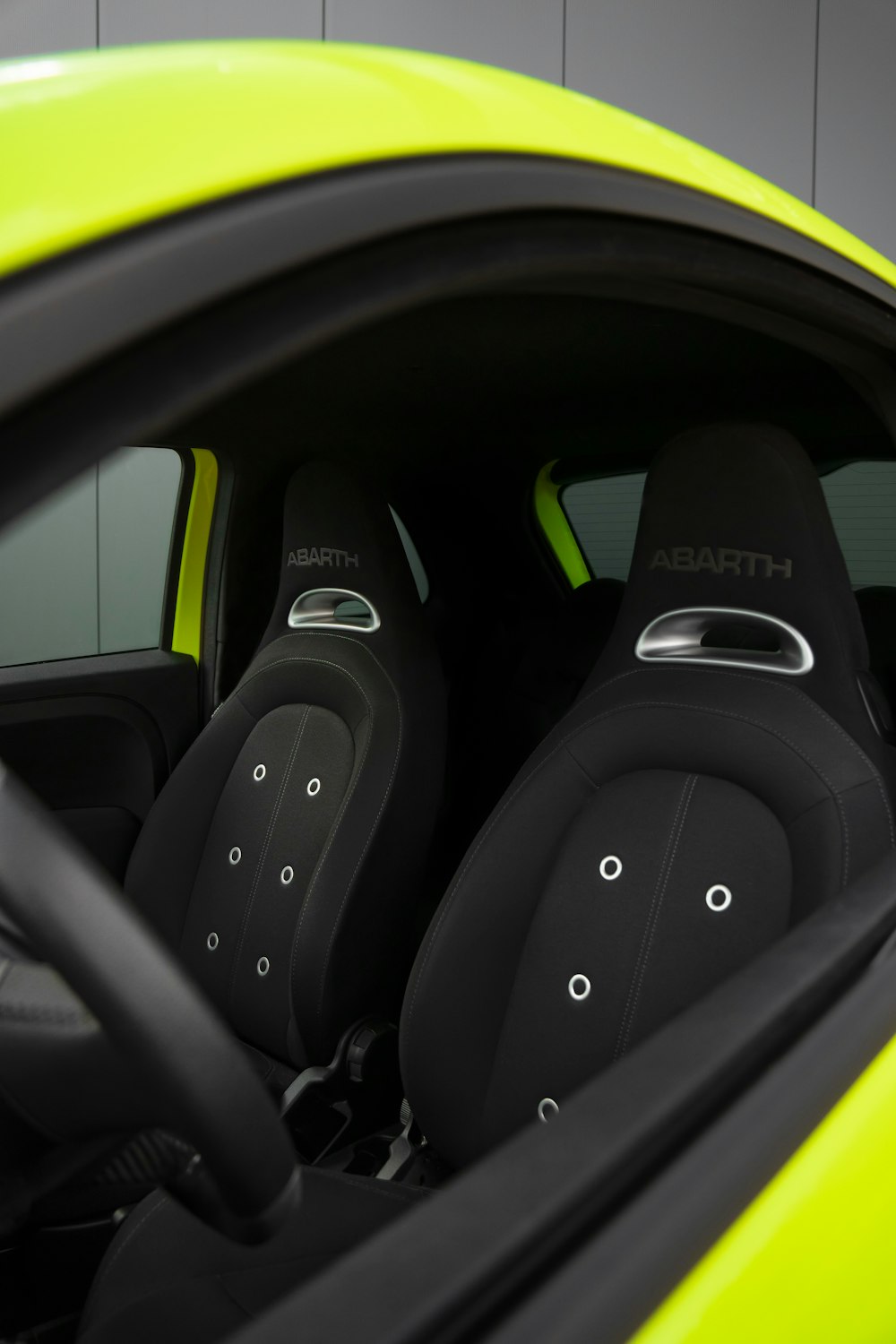 the interior of a sports car with black leather seats