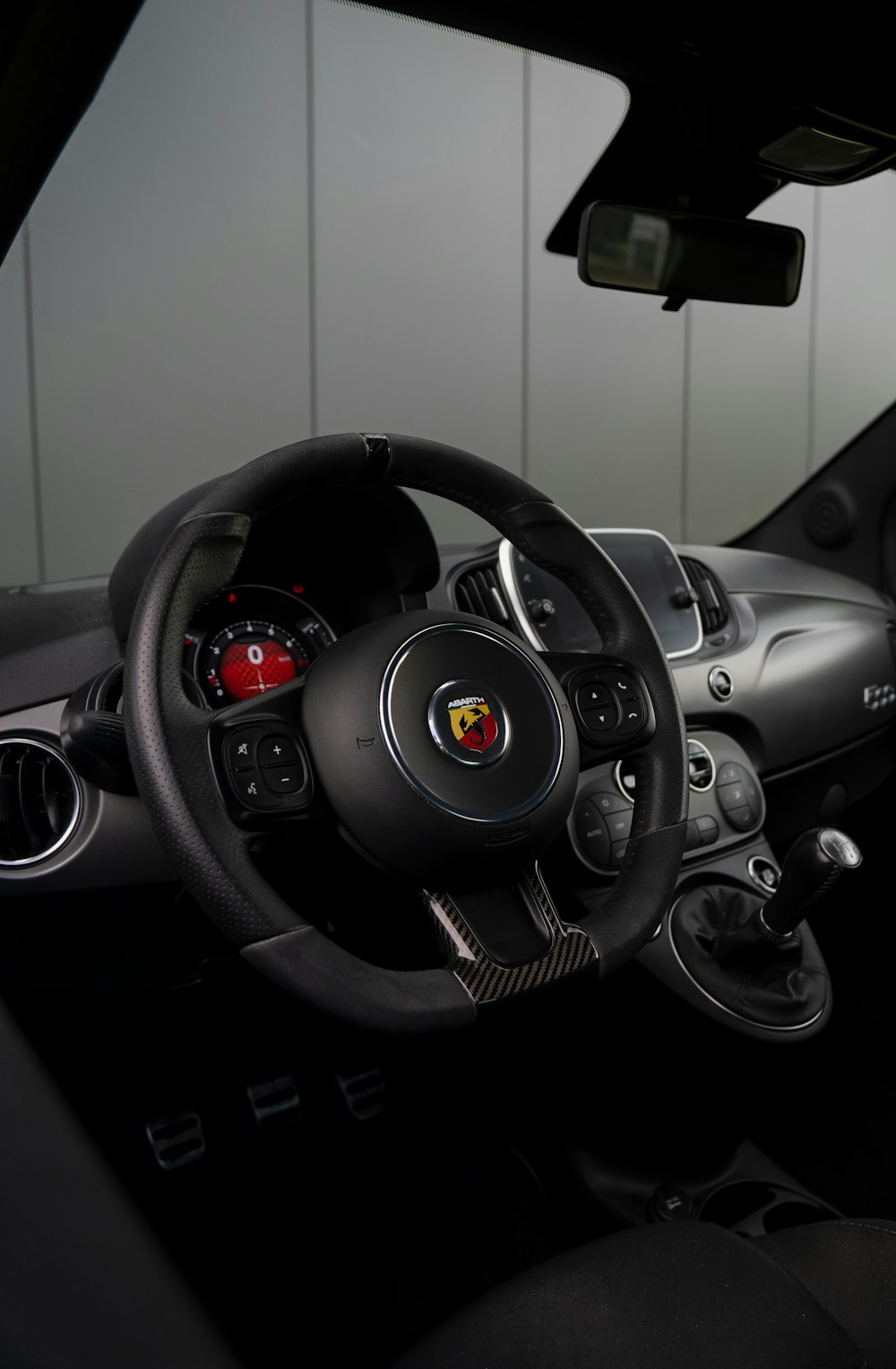 the interior of a car with a steering wheel and dashboard