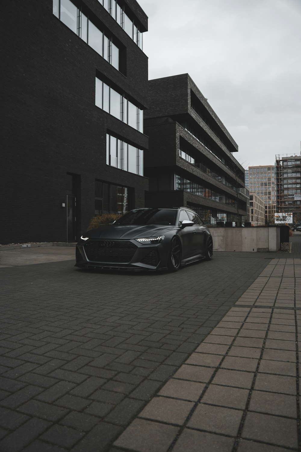 a black sports car parked in front of a building