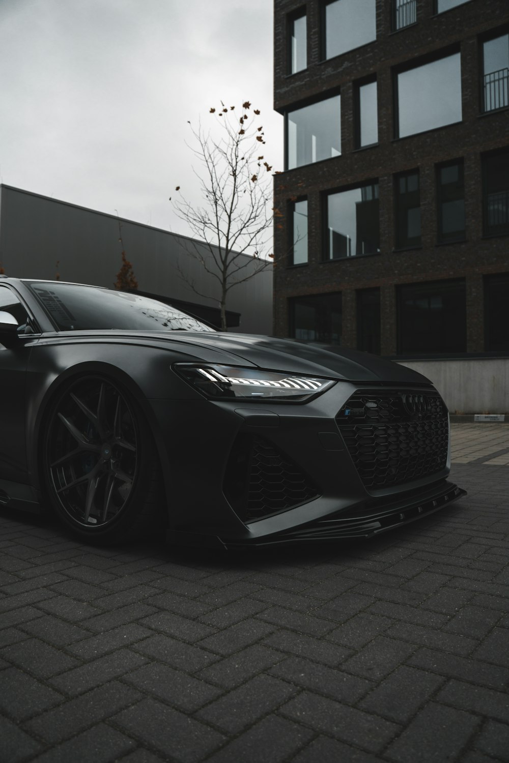 a black sports car parked in front of a building