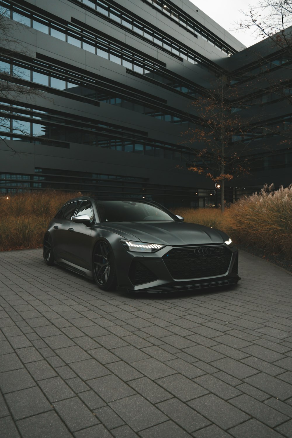 a black car parked in front of a building