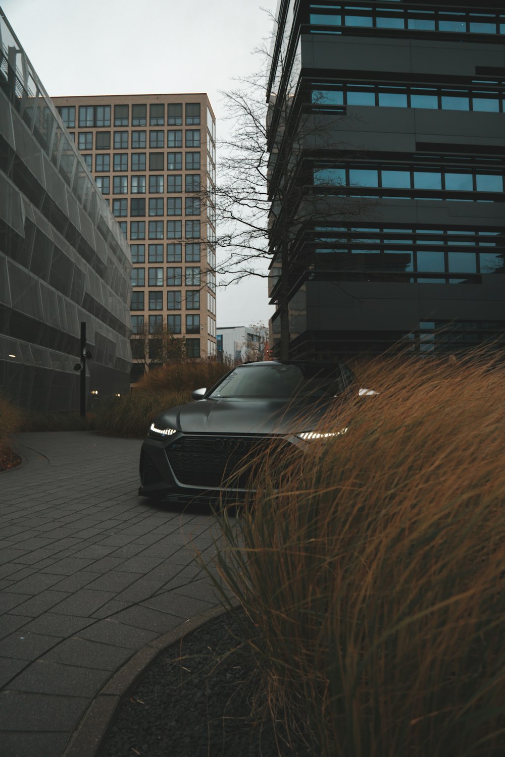 a car parked in front of a tall building