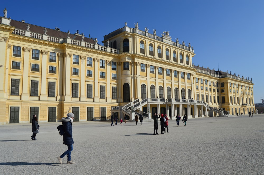 a group of people standing in front of a large building