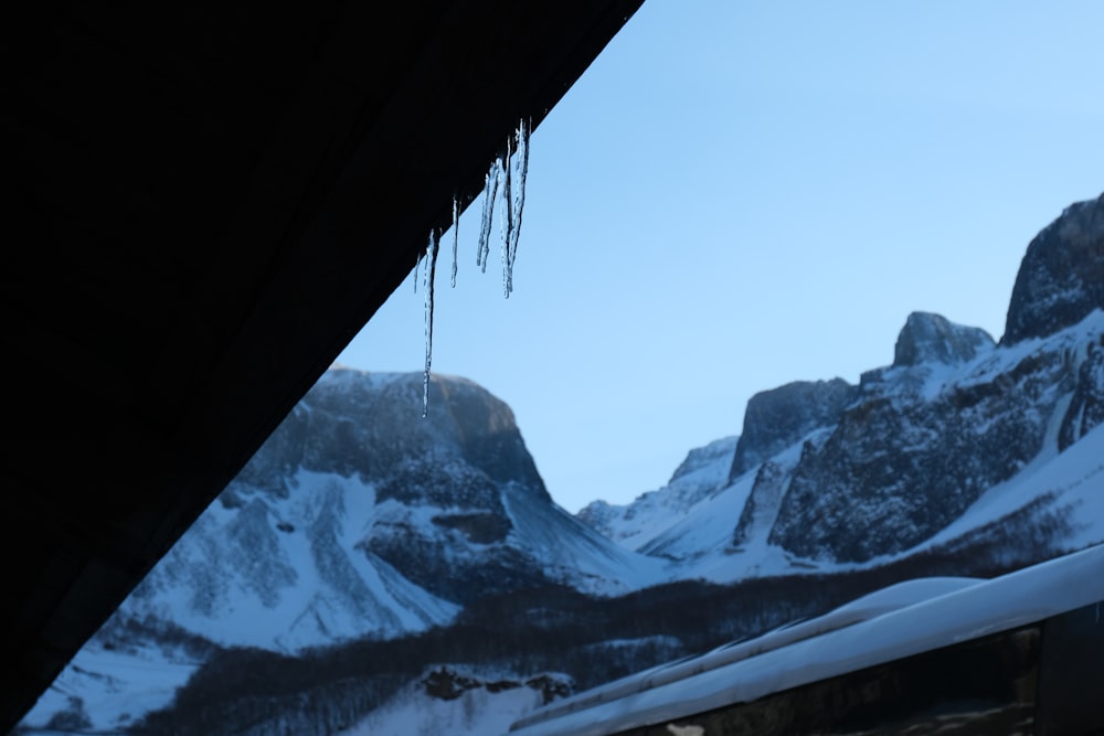 a view of a mountain range from inside a vehicle