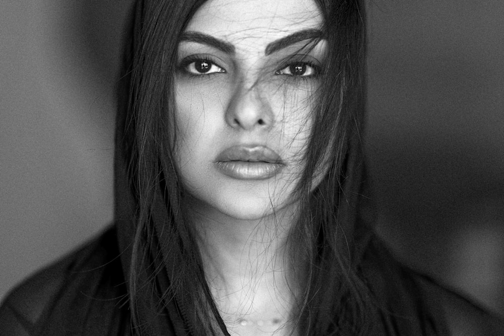 a black and white photo of a woman with long hair