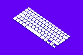 Close-up of hands typing on a modern keyboard with a clean, minimalistic background