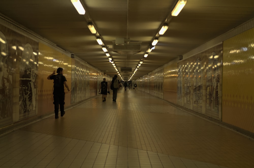 a group of people walking down a long hallway