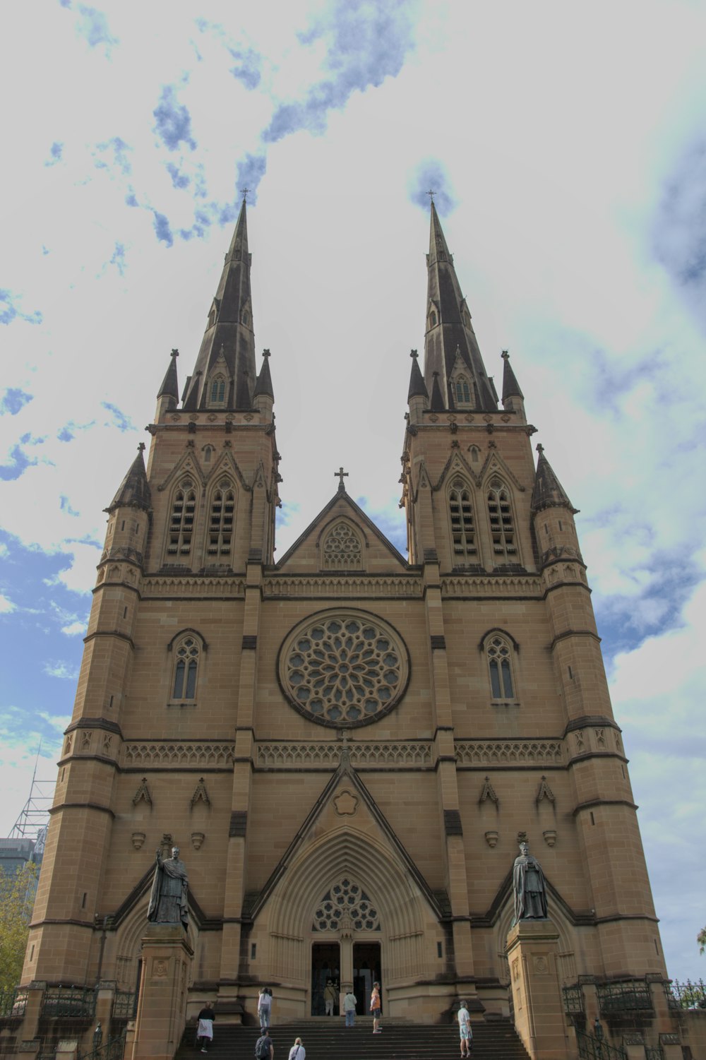 a large cathedral with two steeples and a sky background