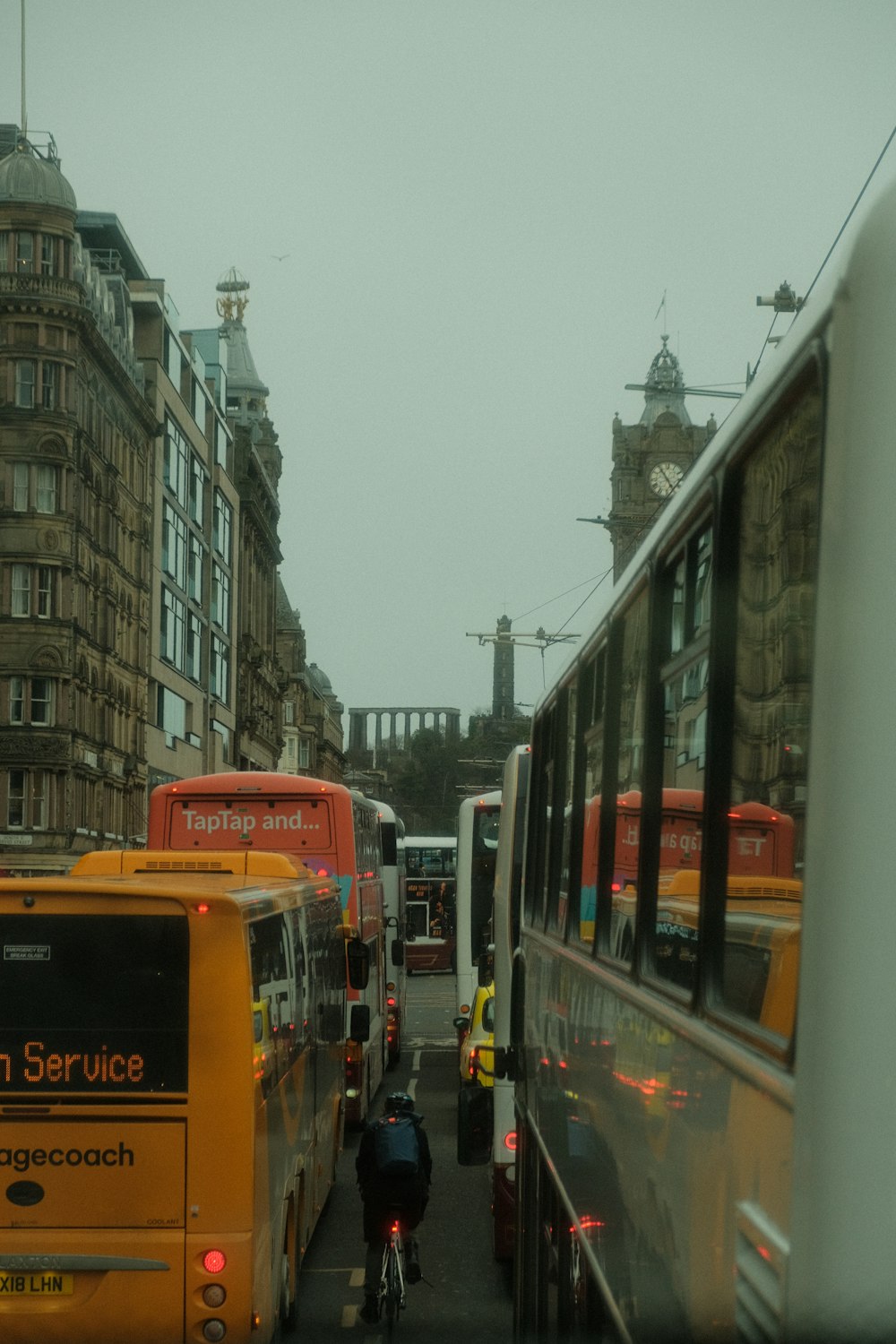 a couple of buses that are sitting in the street