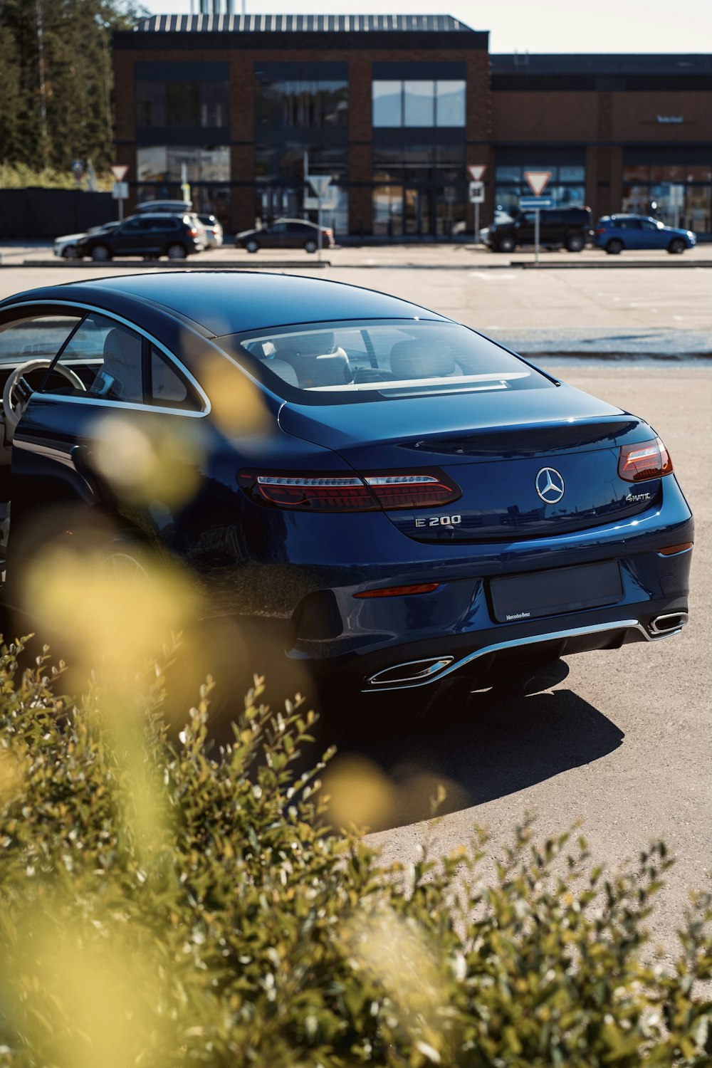 a blue car parked in a parking lot