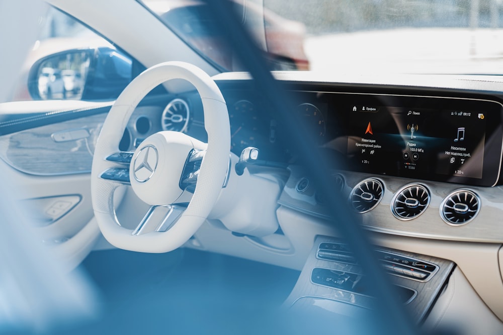 a car dashboard with a steering wheel and a dash board