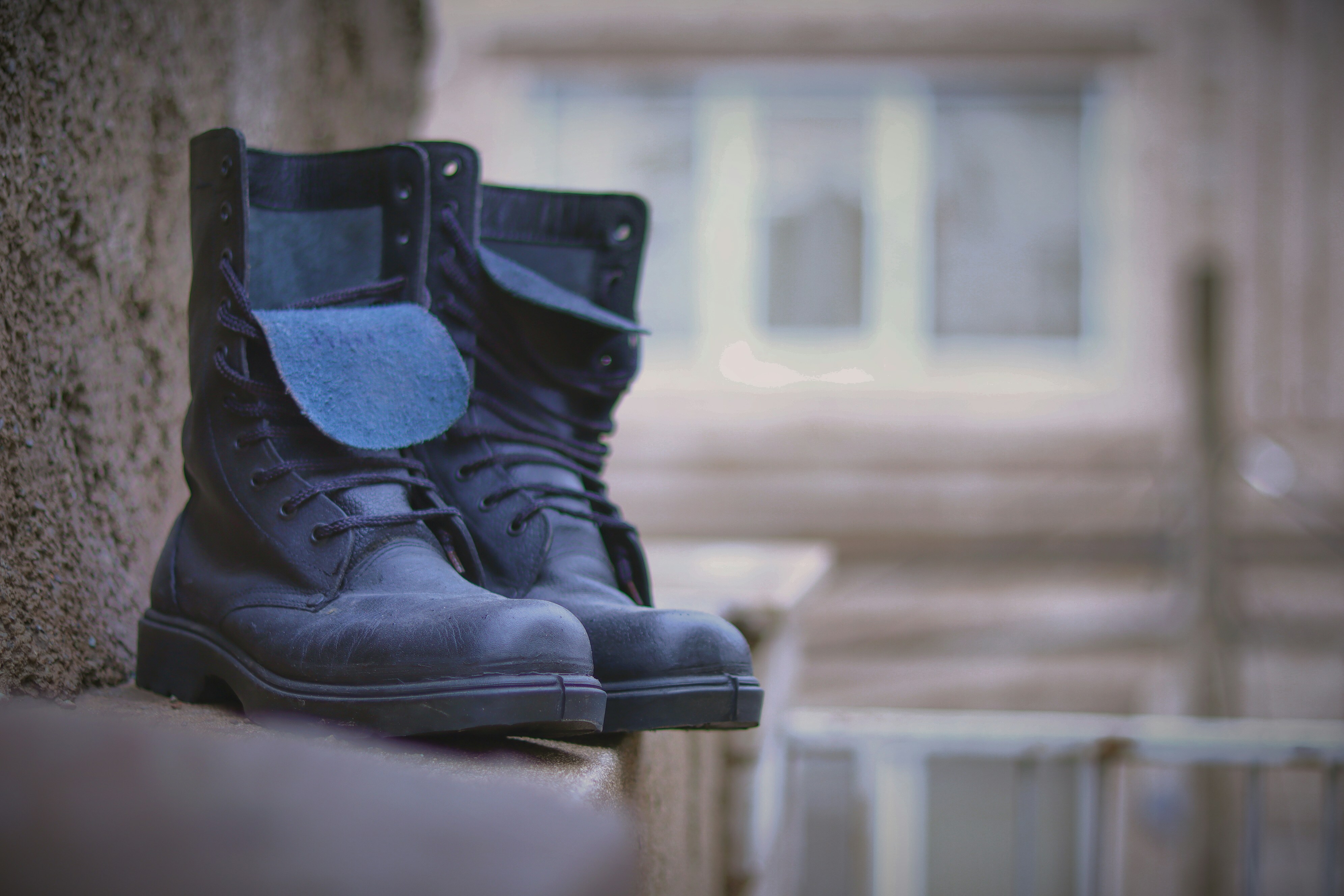a pair of black boots sitting on a ledge