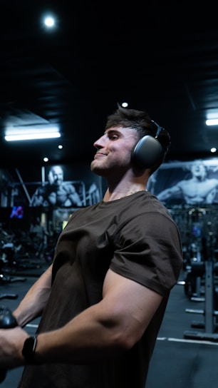 a man wearing headphones in a gym