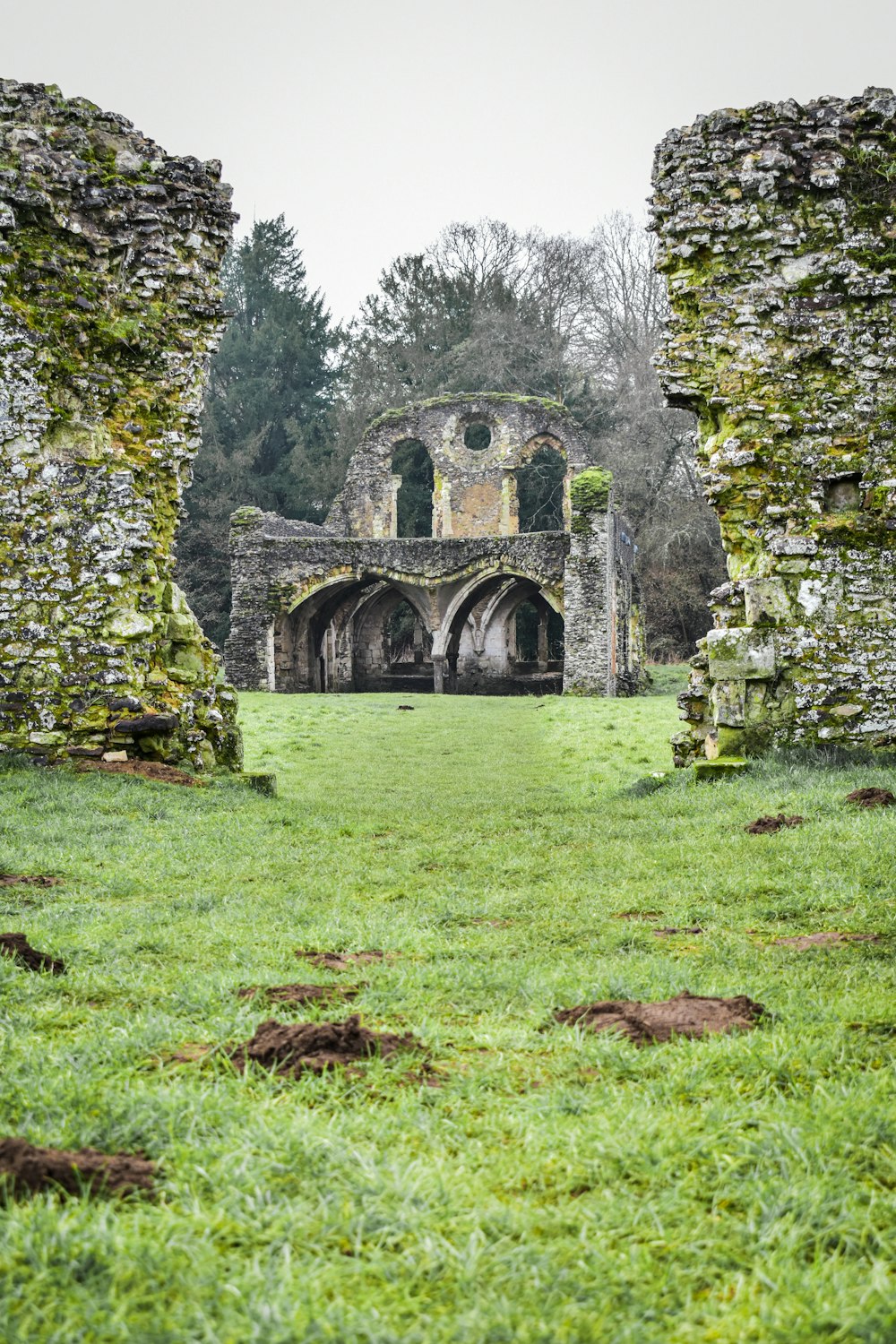 the ruins of an old church in a field