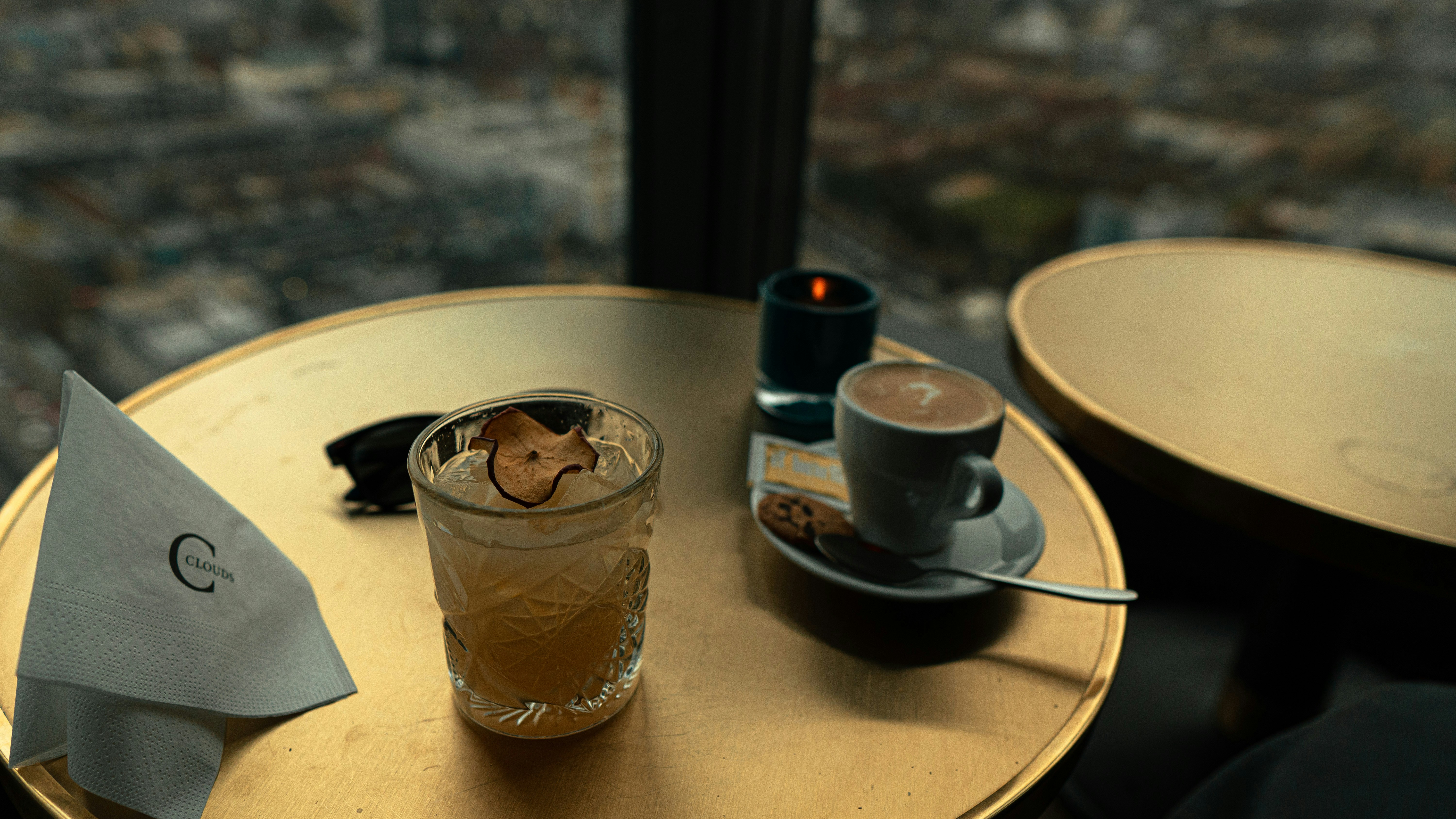 a table with two cups of coffee and a napkin on it, Went to the highest spot in Switzerland, Prime Tower Zurich. Amazing views.