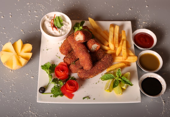 a white plate topped with french fries and other foods