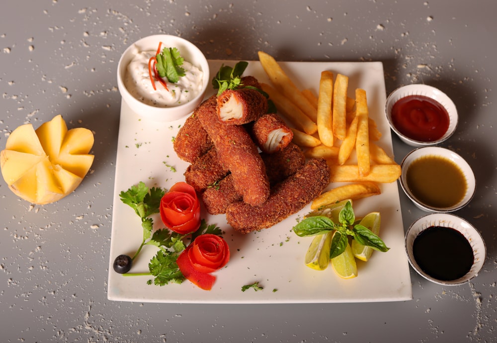 a white plate topped with french fries and other foods