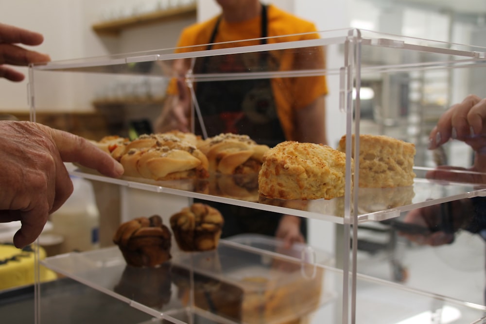 a display case filled with pastries in a bakery