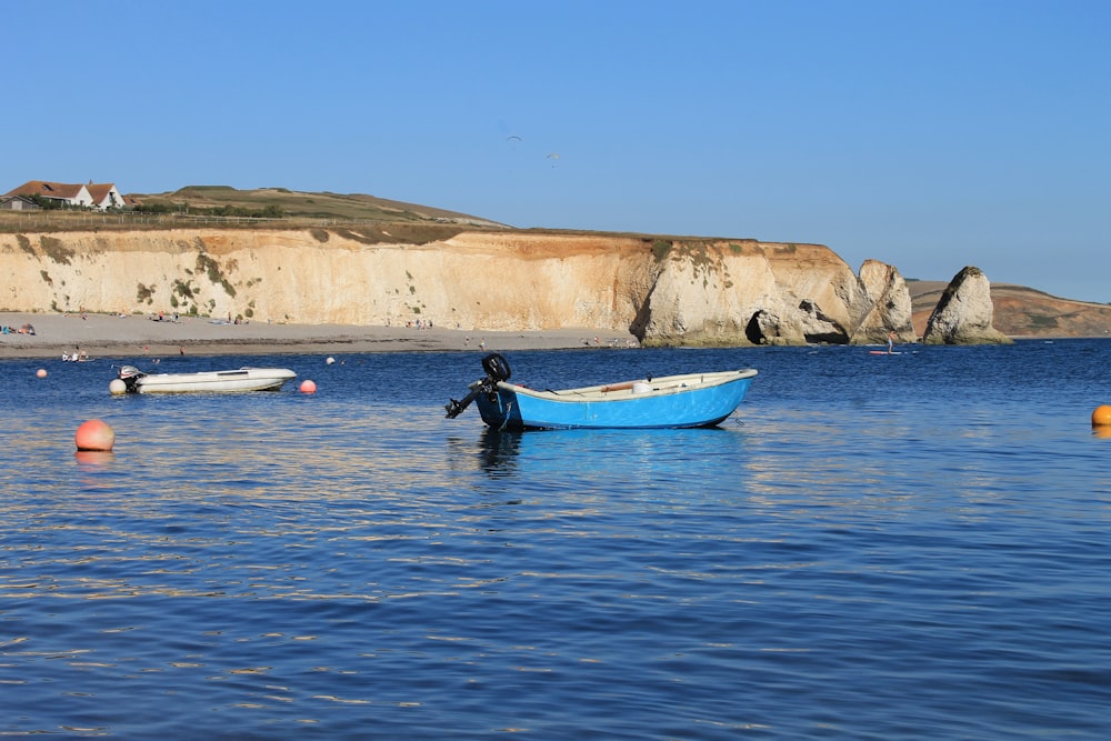 a person sitting in a small boat in the water