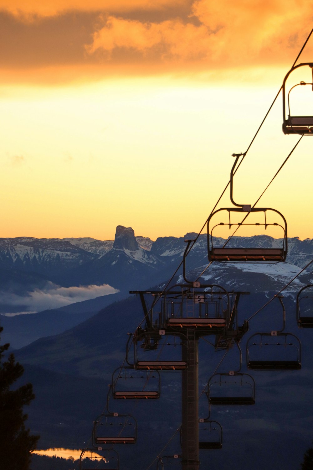 a ski lift with a mountain in the background