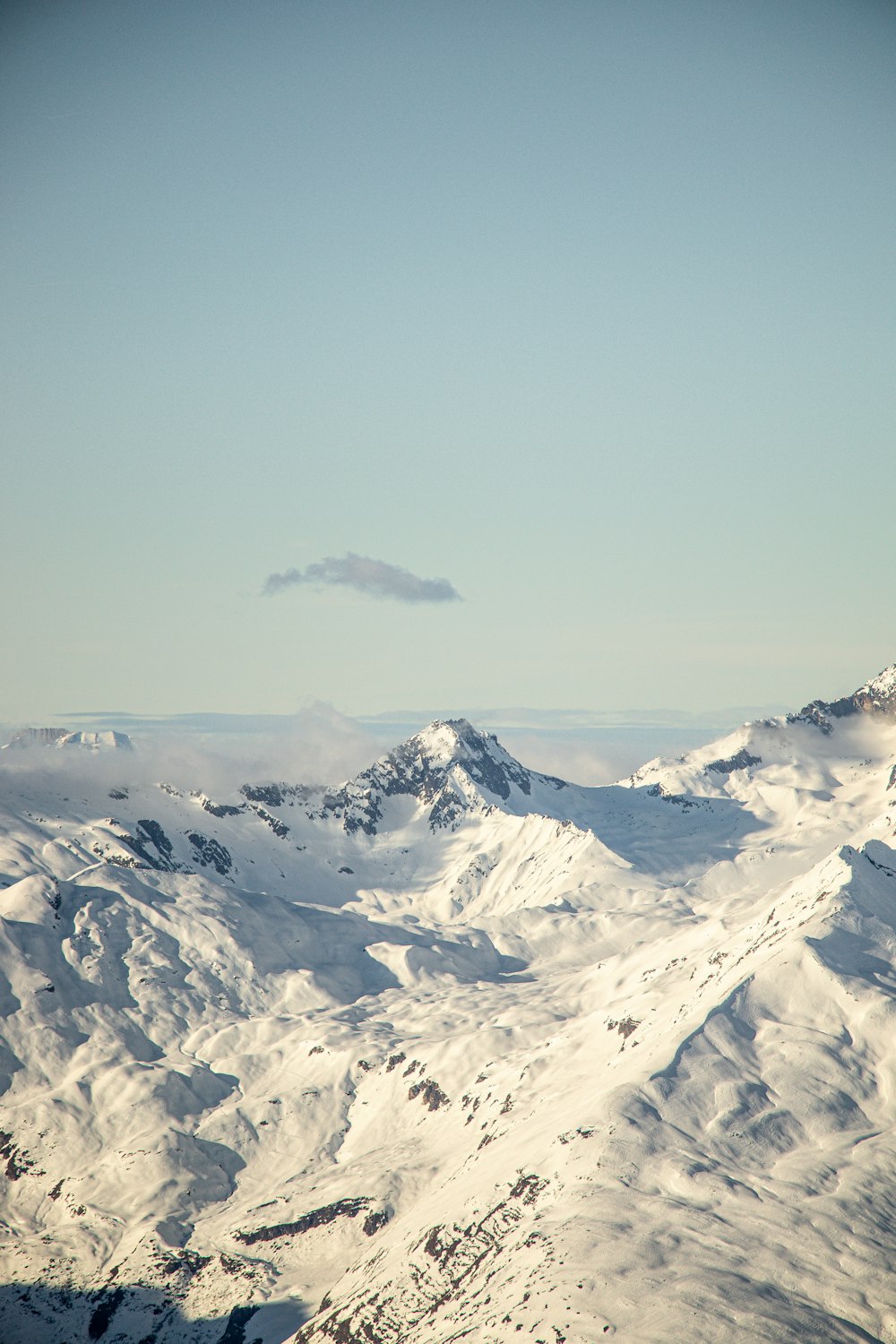 a view of a mountain range covered in snow